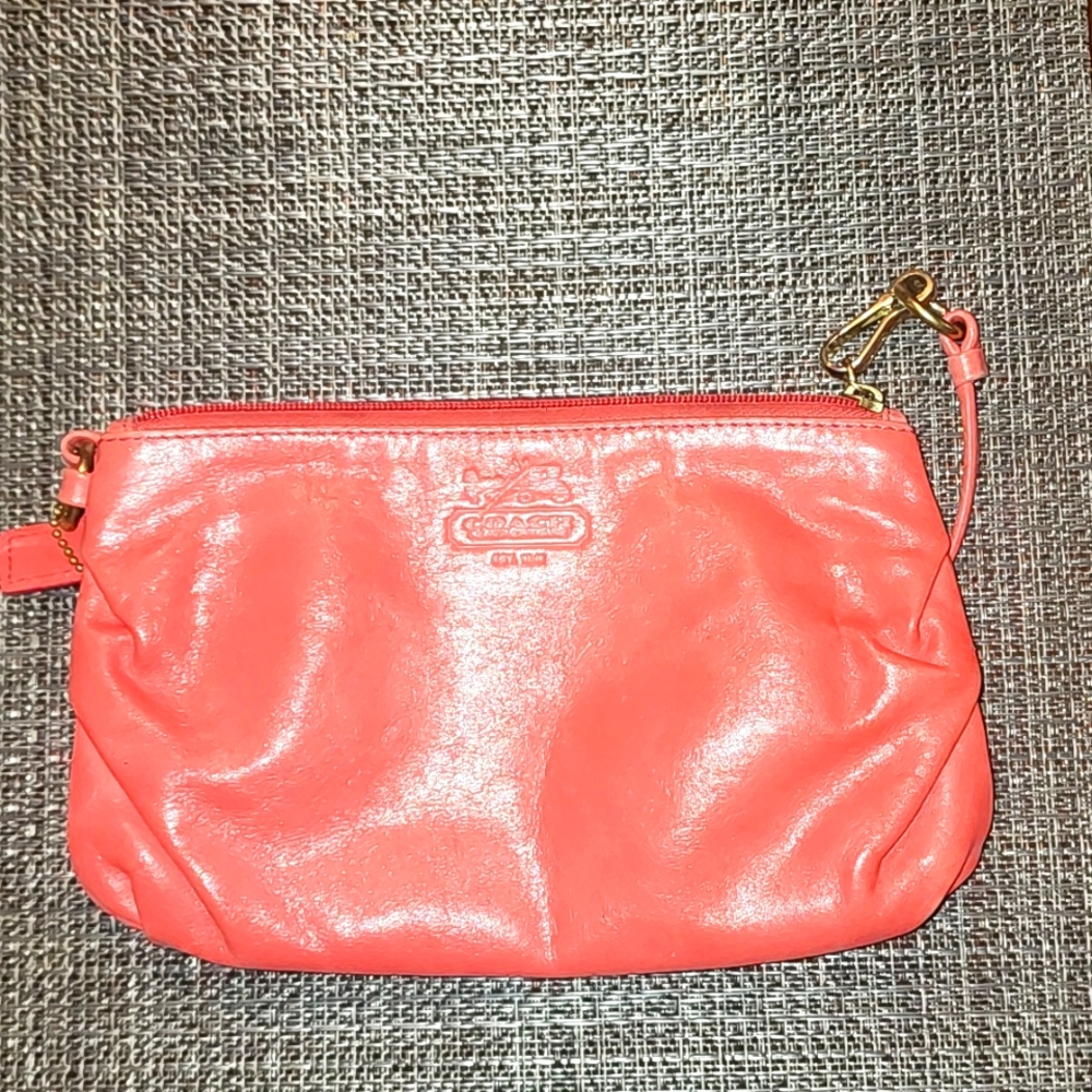 This is a Coral Coach Clutch.It is slightly used, but the perfect bag for summer